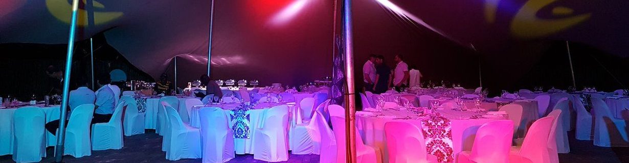 Corporate gala dinner in a stretch tent with event lighting