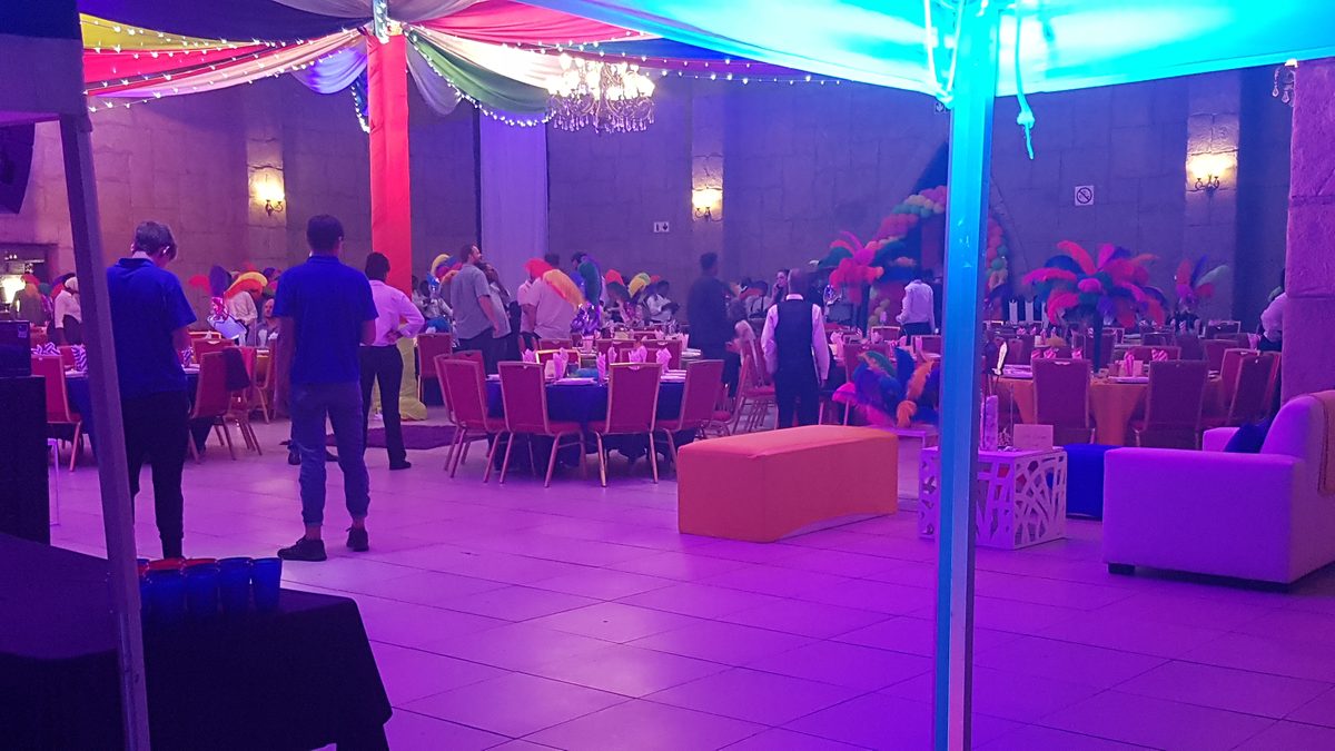 Carnival themed corporate evening with feathered centrepieces and lounge seating