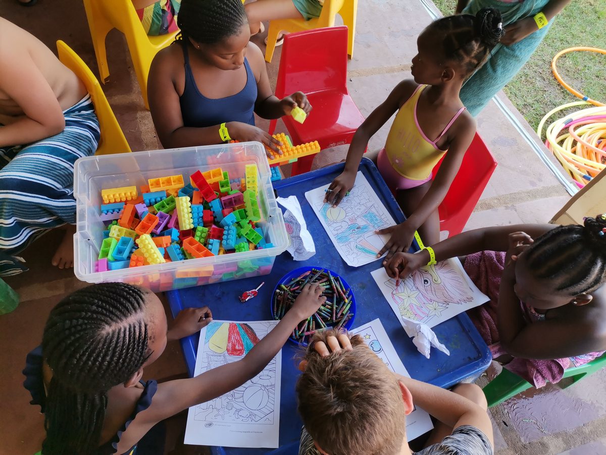 Children building with blocks and colouring at a resort kids club