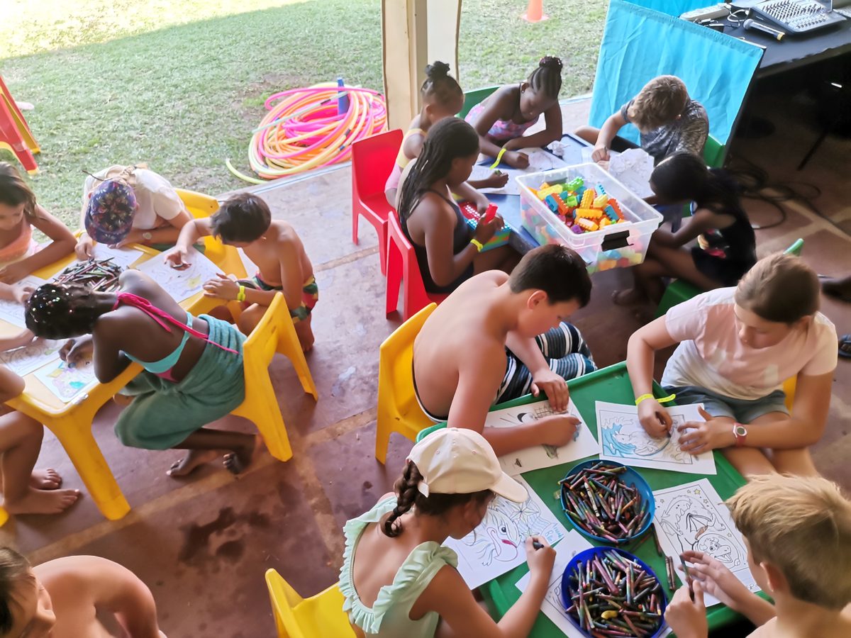 Kids club colouring and activity tables at a resort holiday programme