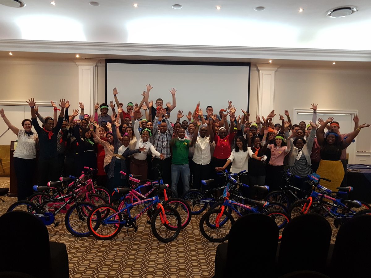 Corporate team celebrating after a charity bike build