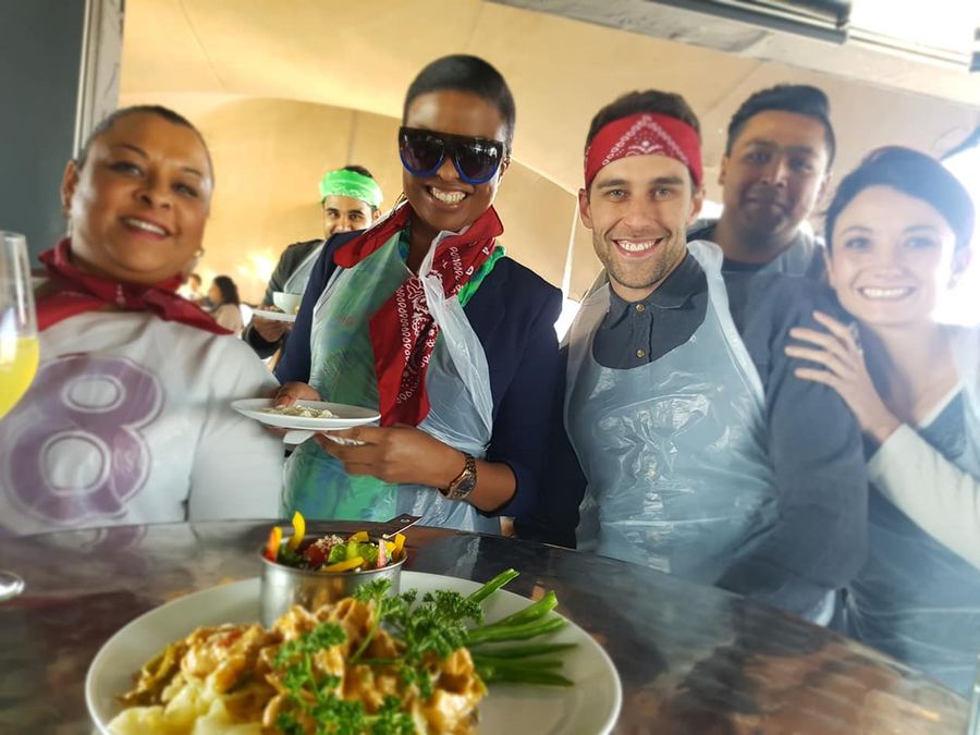 Teams preparing food during a cook-off team building challenge