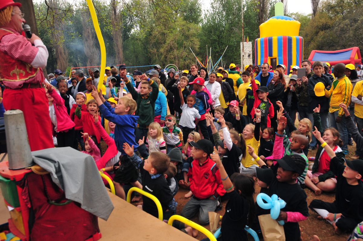Children enjoying entertainment at a corporate year-end family day
