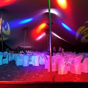 Corporate gala dinner in a stretch tent with event lighting